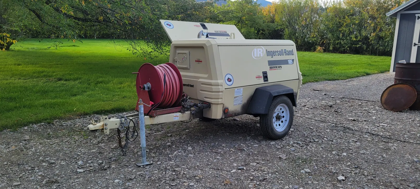 Our tow-behind air compressor with a hose reel, set up for a sprinkler blowout
