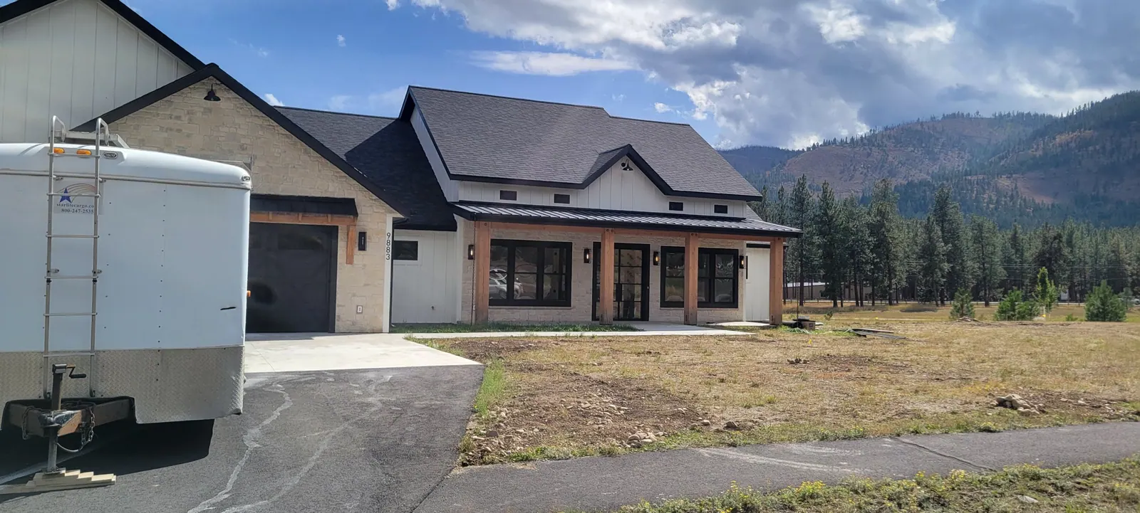 A newly built Montana home with a bare dirt yard waiting for sprinklers and landscaping